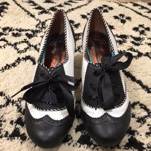 Black and white wingtip heels